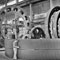 picture of a man working with some gears/machinery